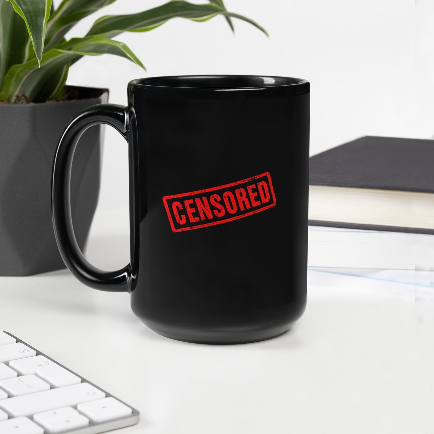 Black glossy 15 oz mug with handle on the left, featuring a censored design, by wayward.biz.
