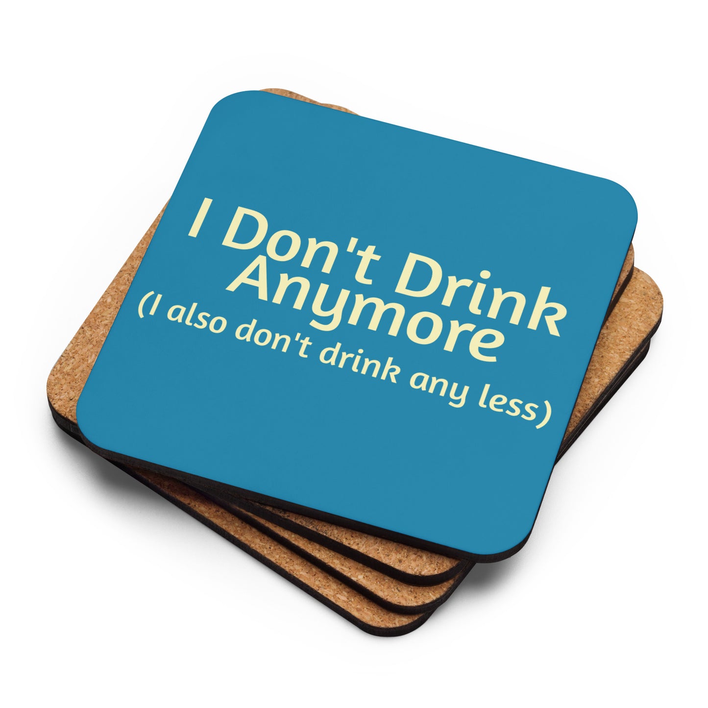 Cork-back sublimation coaster with "I Don't Drink Anymore (or less)" text, featuring a colorful, humorous design on a wooden surface.