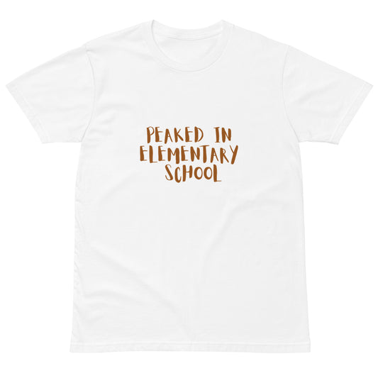 Unisex white premium T-shirt with "Peaked in Elementary School" graphic, casual fit, lightweight fabric, from wayward.biz.