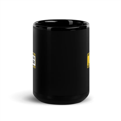Black glossy 15 oz mug with "May Contain Sarcasm" text, designed by wayward.biz, shown from the front.