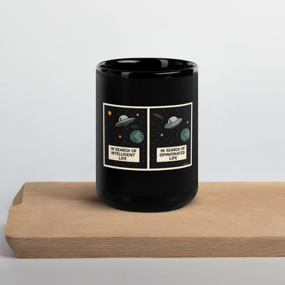 15 oz black glossy mug featuring "In Search of Intelligent / Opinionated Life" text, made by wayward.biz.