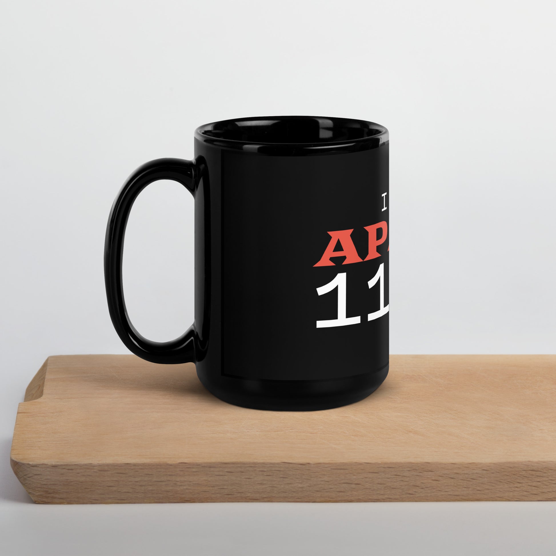Black glossy 15 oz mug with handle on the left, featuring "I Give Apathy 110%" text, ideal for coffee or tea.