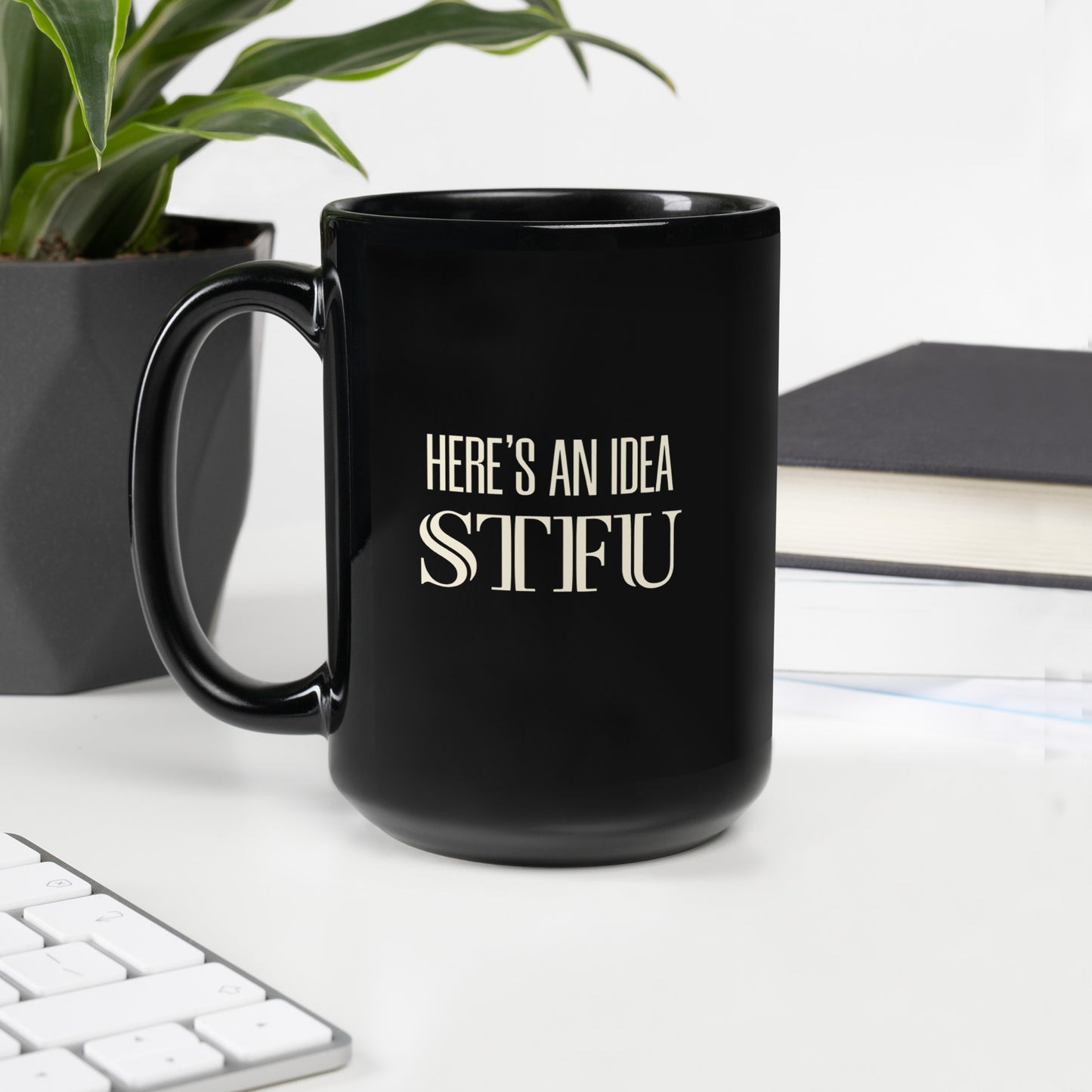 Black glossy mug with "Here's an Idea - STFU" text, 15 oz capacity, handle on the left, by wayward.biz