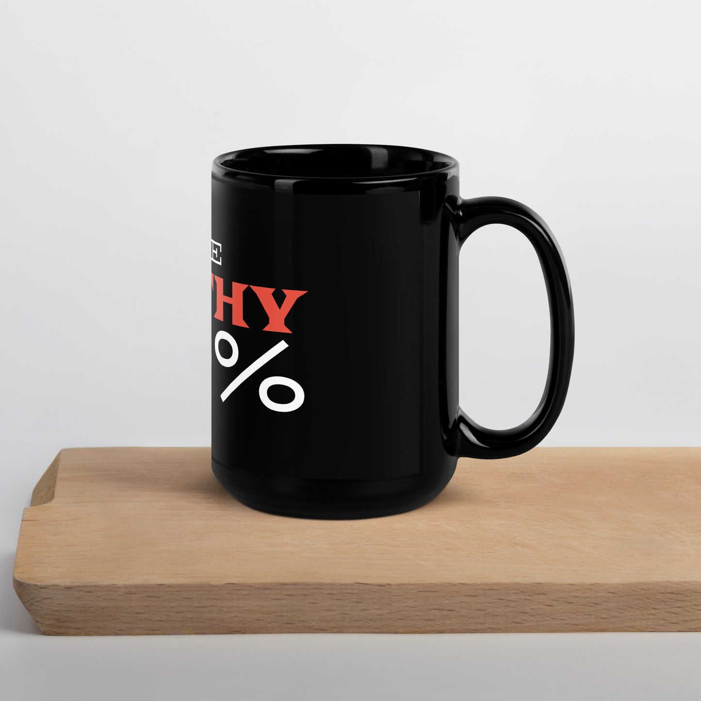 Black glossy 15 oz mug with handle on the right, featuring "I Give Apathy 110%" text, from wayward.biz.