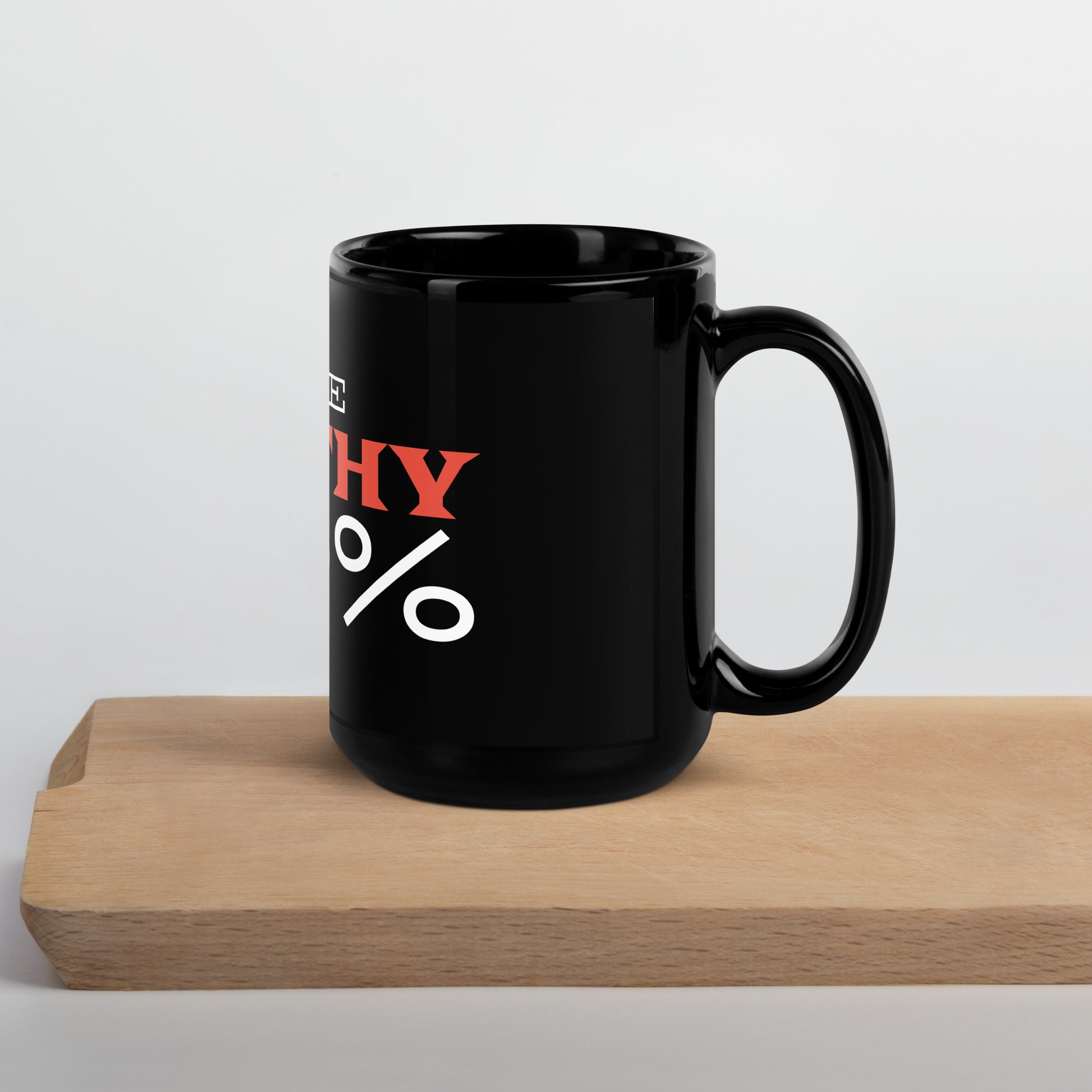 Black glossy 15 oz mug with handle on the right, featuring "I Give Apathy 110%" text, from wayward.biz.