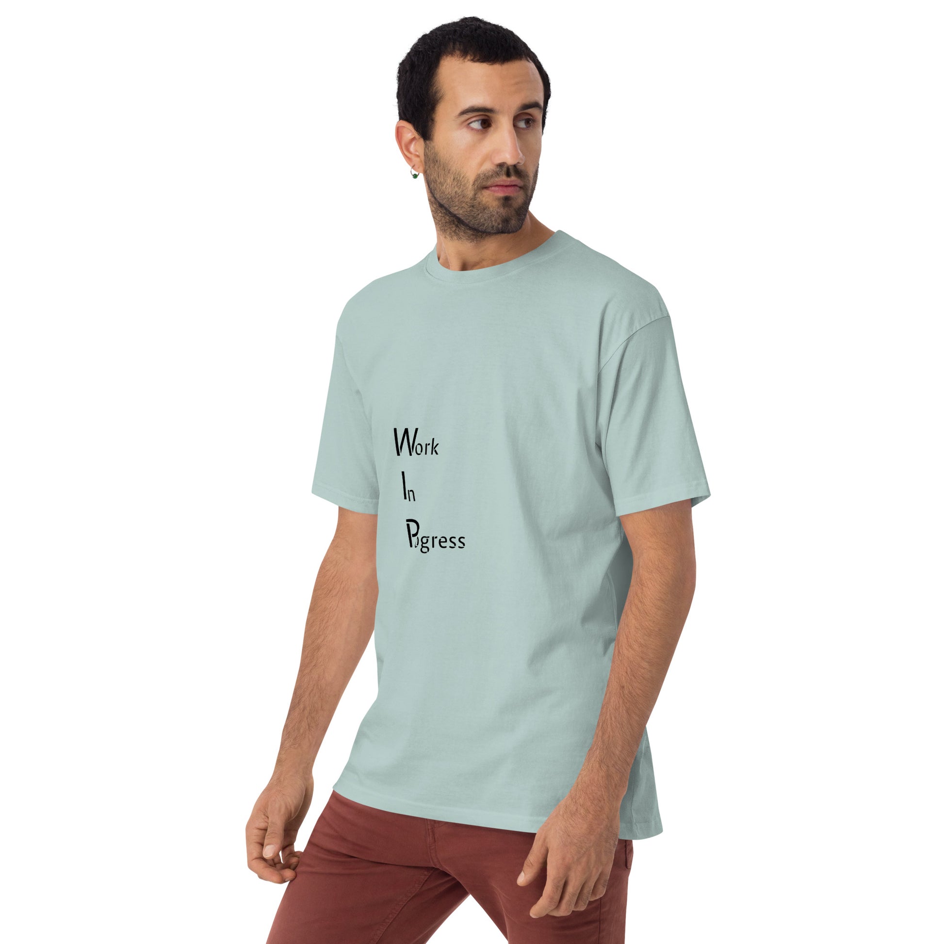 Men's premium heavyweight T-shirt from Work in Progress by wayward.biz, shown in agave color with left-front design.
