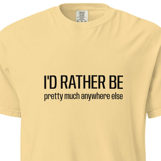 Unisex garment-dyed heavyweight T-shirt with "I'd Rather Be... anywhere else" text on the front, in a buttery color.