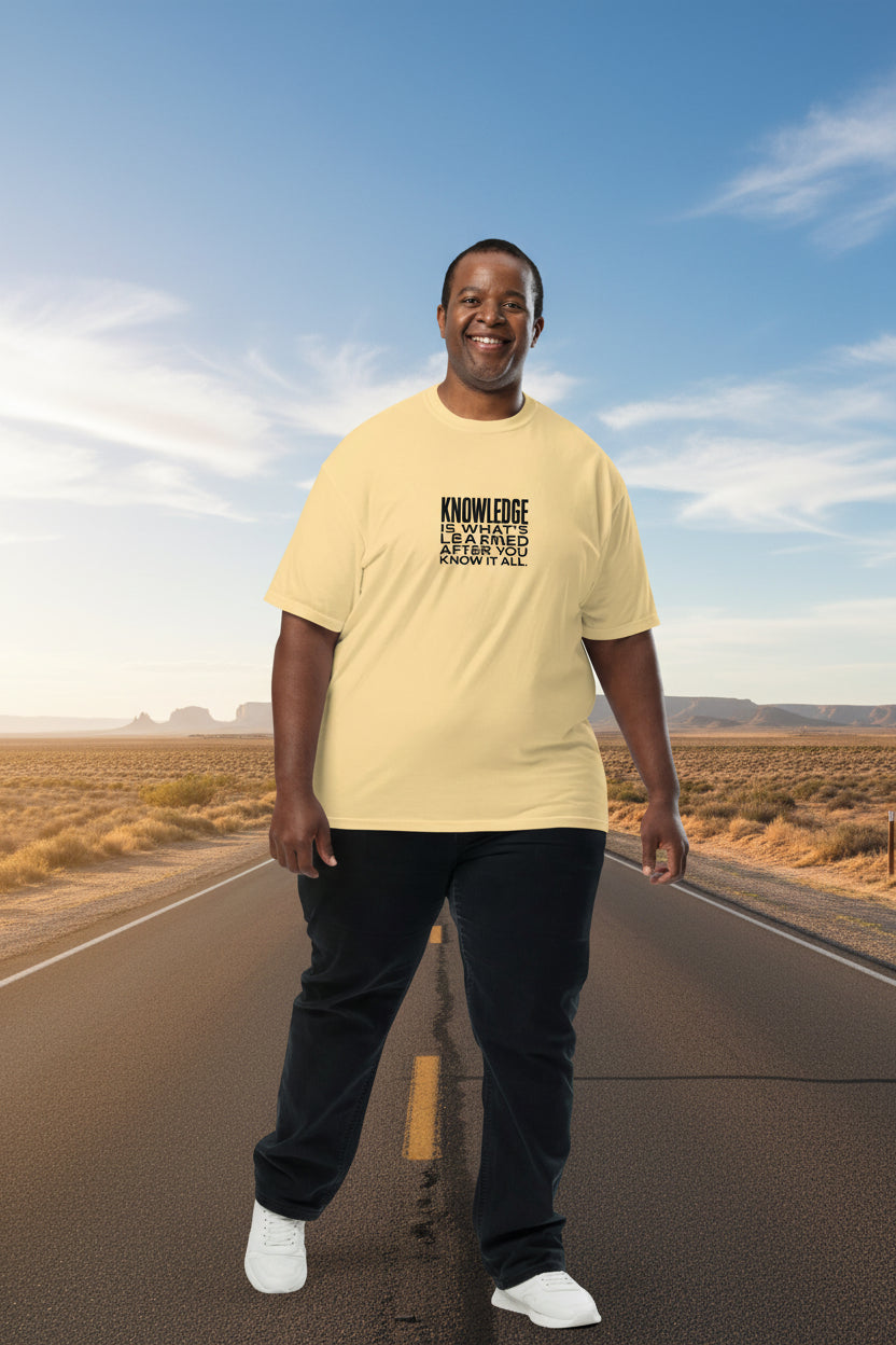 Unisex garment-dyed heavyweight T-shirt by wayward.biz with "Knowledge is what's learned after you know it all" printed on the front.
