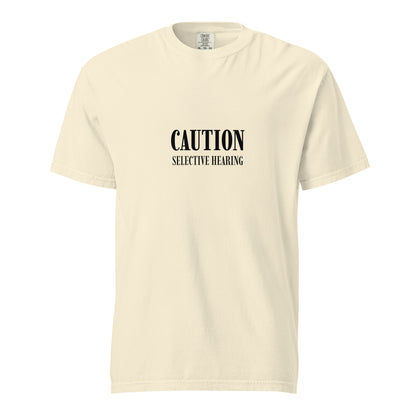 Unisex garment-dyed heavyweight T-shirt in ivory with caution: selective hearing printed front, by wayward.biz.