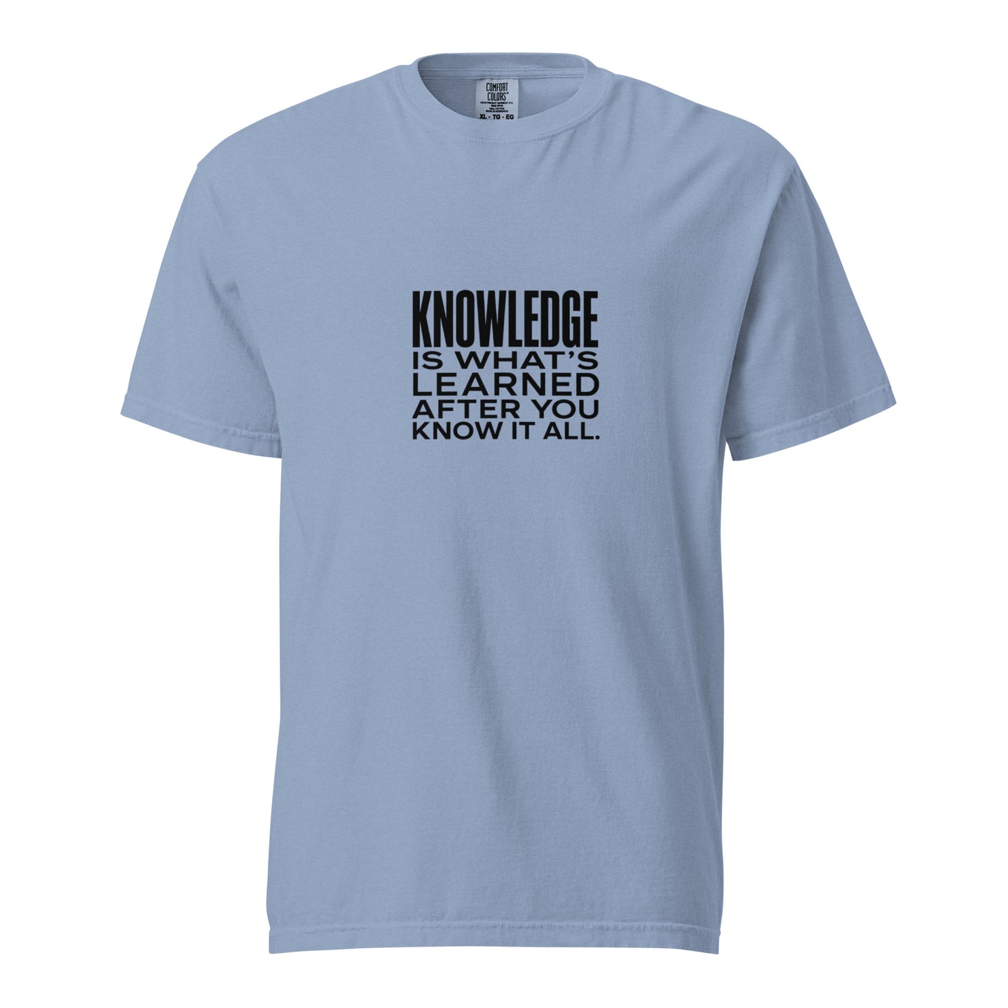 Unisex garment-dyed heavyweight T-shirt with washed denim finish, featuring the phrase "Knowledge is what's learned after you know it all."