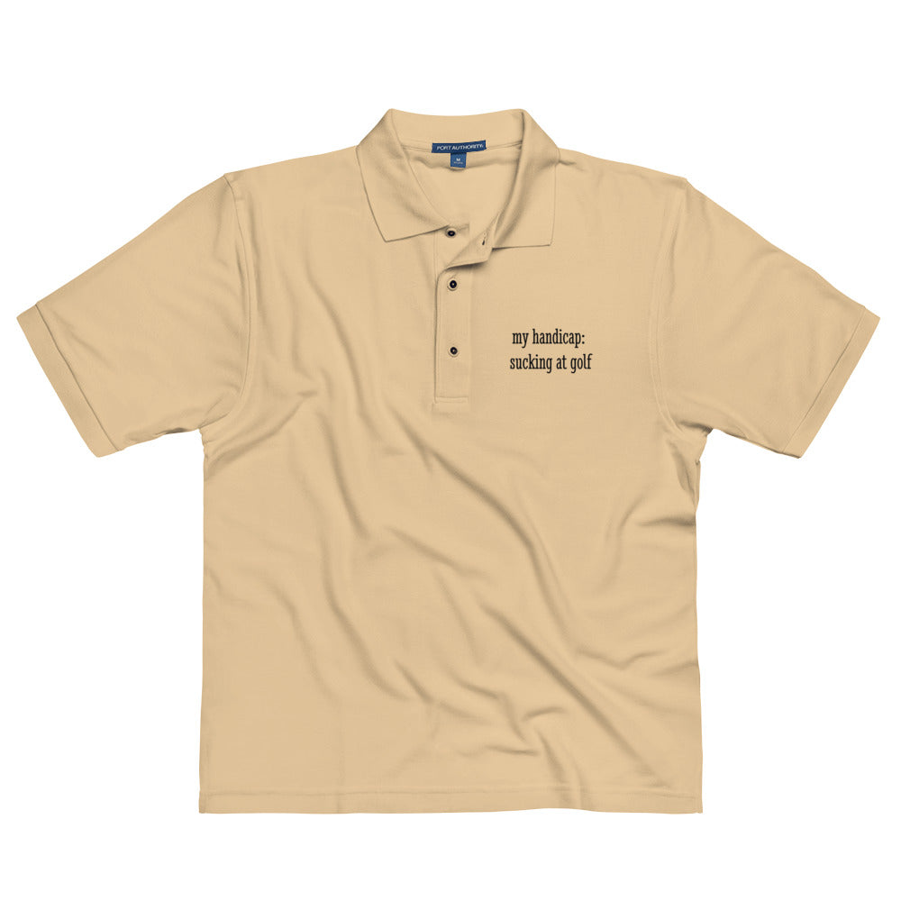 Unisex stone-colored premium polo shirt for men with "My handicap: Sucking at Golf" slogan from wayward.biz.