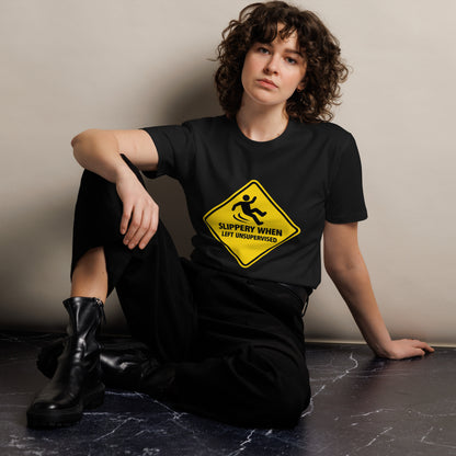 Unisex black premium T-shirt from wayward.biz with "Slippery When Left Unsupervised" graphic on front.