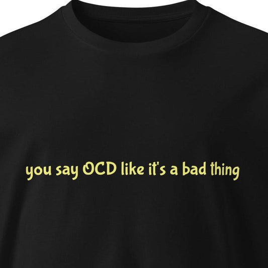 Black unisex premium T-shirt with "You say OCD like it's a bad thing" text, from Wayward.biz, front view.