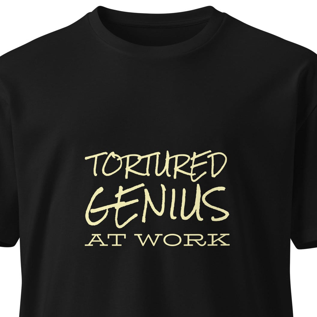 Unisex black premium T-shirt featuring a "Tortured Genius at Work" graphic design, casual style from wayward.biz.