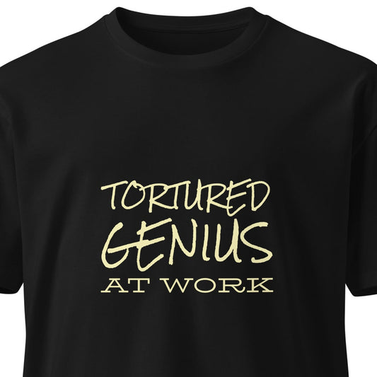 Unisex black premium T-shirt featuring a "Tortured Genius at Work" graphic design, casual style from wayward.biz.