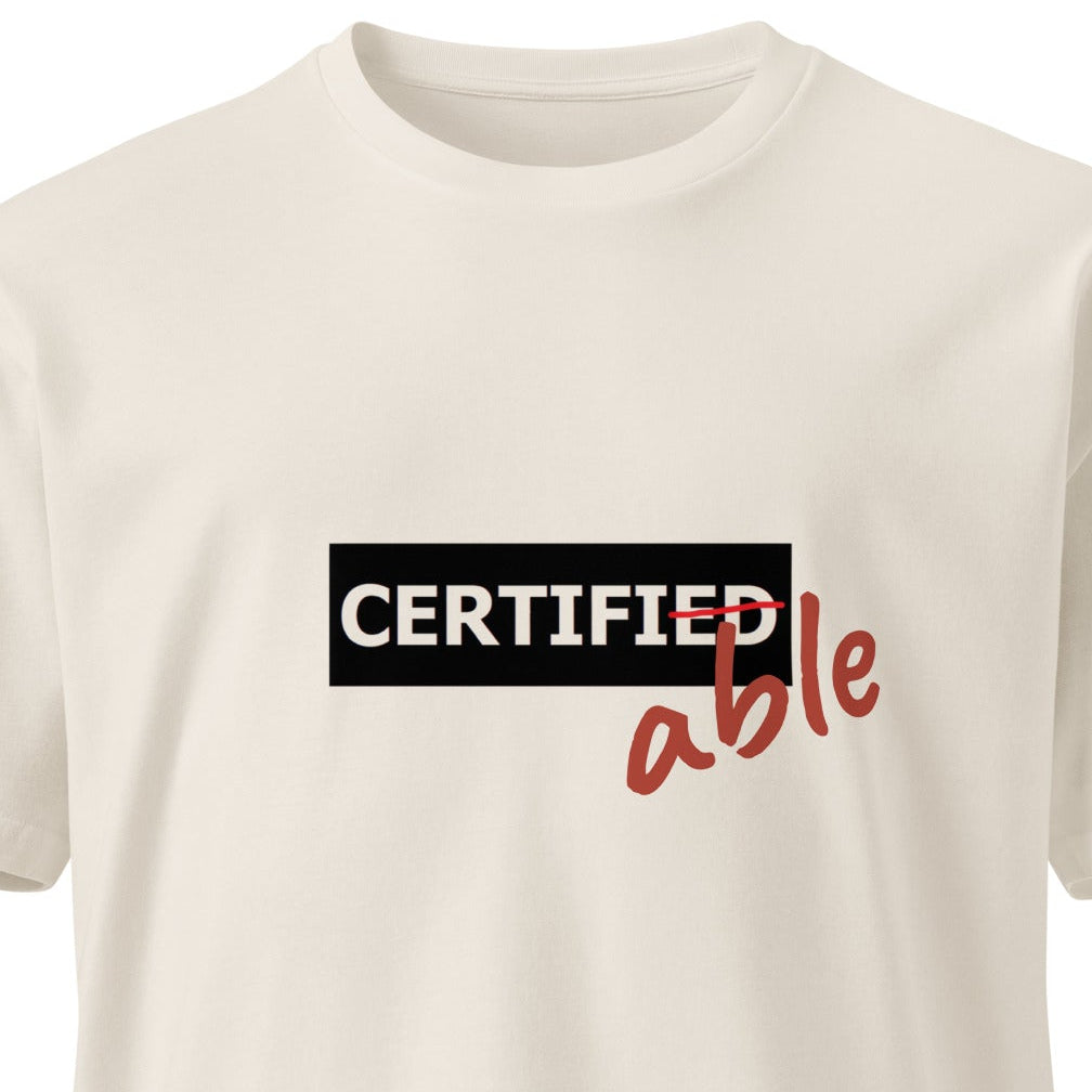 Unisex premium T-shirt in bone color with wayward.biz branding, front view showing soft fabric and classic fit.