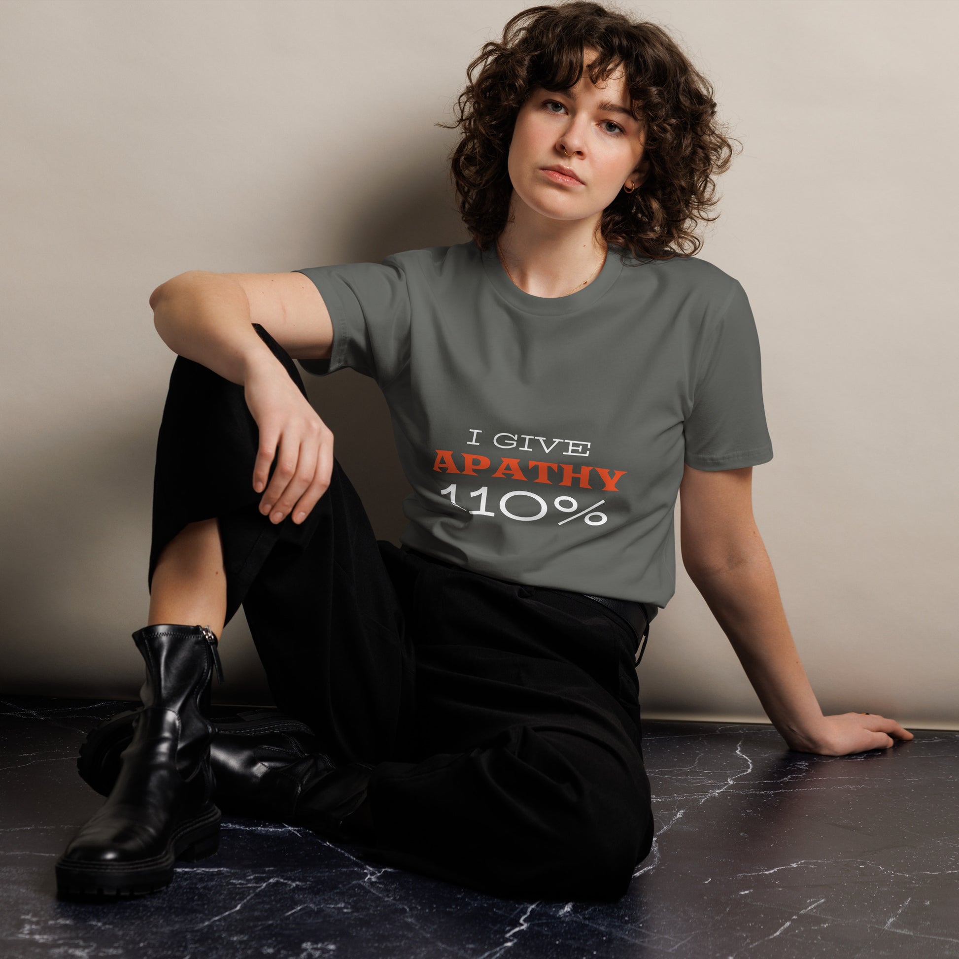 Unisex dark charcoal I Give Apathy 110% premium T-shirt by wayward.biz, front view showing minimalist design.