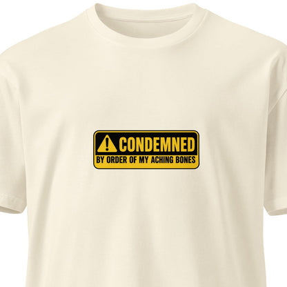 Unisex premium T-shirt with "Condemned by Order of My Aching Bones" design, natural front view, by wayward.biz
