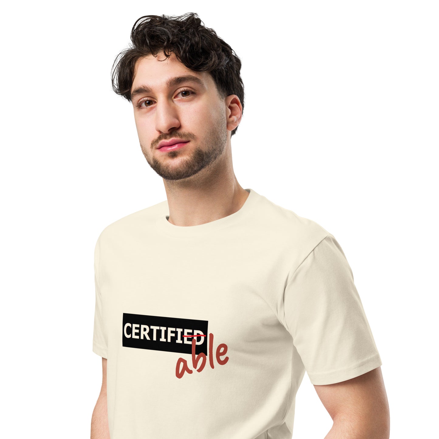Natural-colored unisex premium T-shirt from wayward.biz, displayed from the front left side.