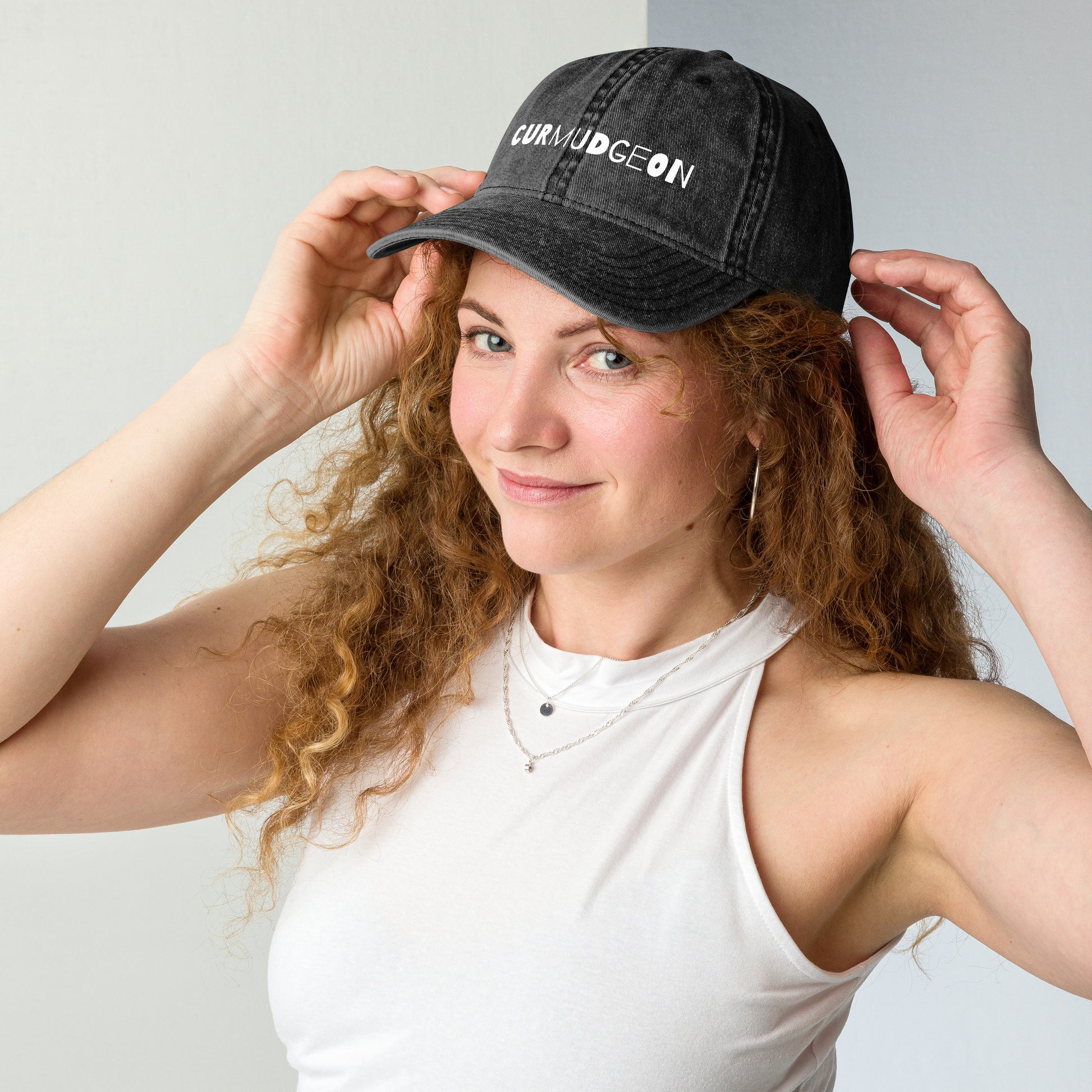 Black vintage cotton twill cap with curved brim, featuring a classic design and Wayward.biz branding on the front.